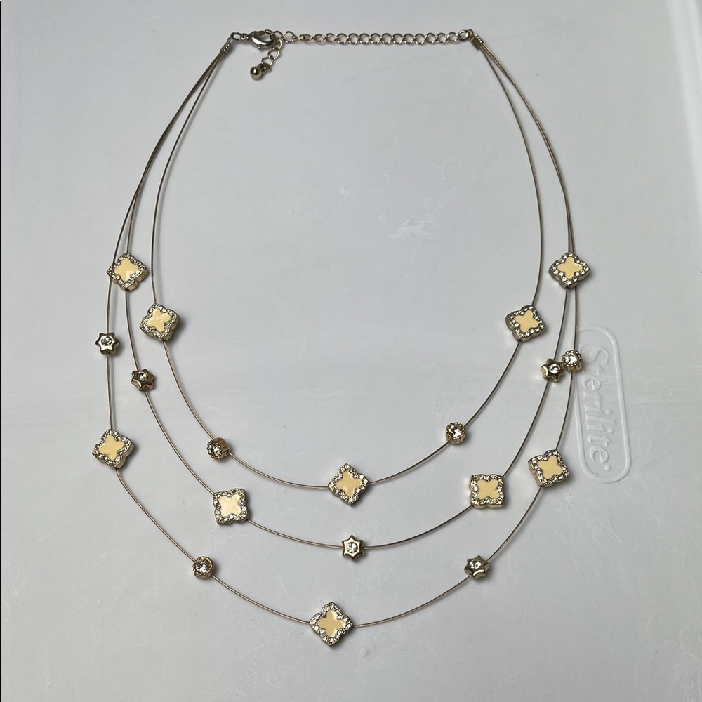 Gold tone multi-layered necklace yellow quatrefoil-shaped charms round crystal